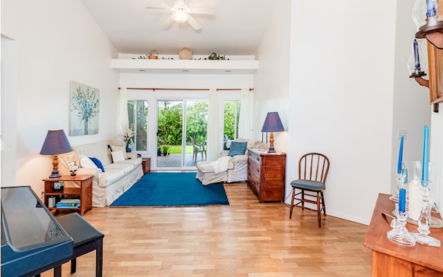 living room with light hardwood / wood-style floors and ceiling fan