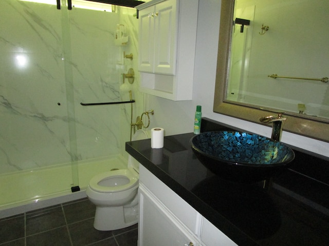 bathroom with vanity, tile patterned floors, a shower with door, and toilet