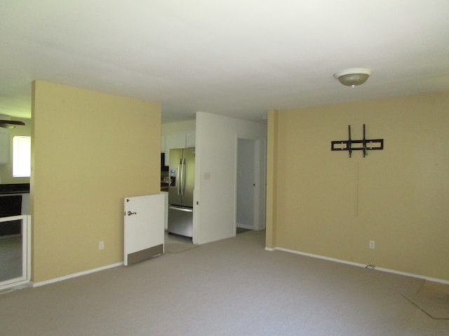 unfurnished room with light colored carpet