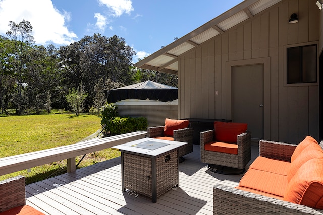 deck featuring an outdoor living space with a fire pit and a yard