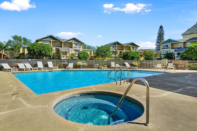 view of swimming pool featuring a community hot tub