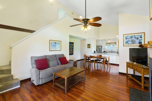 living room with hardwood / wood-style floors, high vaulted ceiling, and ceiling fan