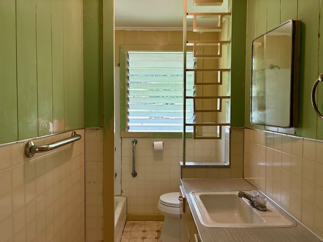 bathroom with tile walls, vanity, and toilet