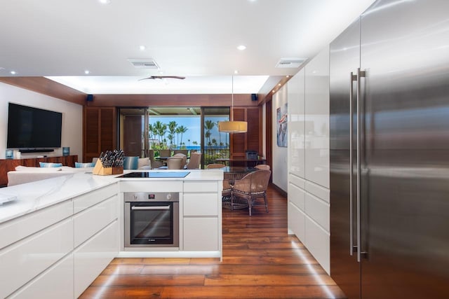 kitchen with appliances with stainless steel finishes, modern cabinets, visible vents, and white cabinetry