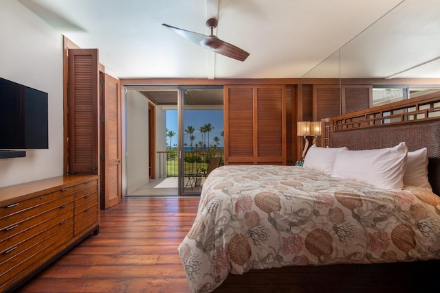 bedroom with access to outside and wood finished floors