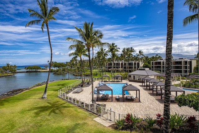 pool featuring a water view, a yard, and a gazebo