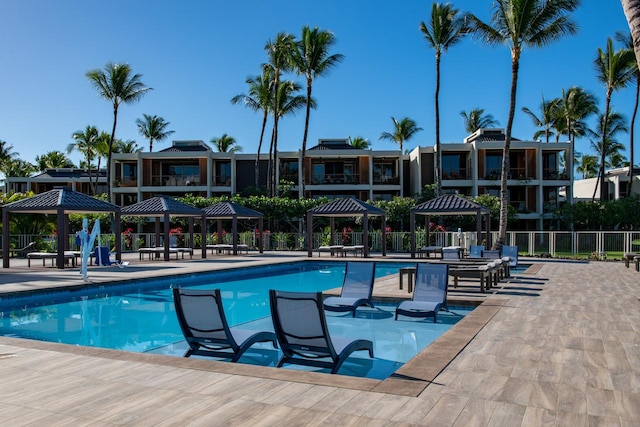 pool with a gazebo, a patio, and fence