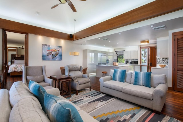 living area with light wood-style floors, visible vents, plenty of natural light, and ceiling fan