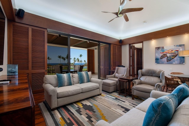 living room with a ceiling fan and wood finished floors