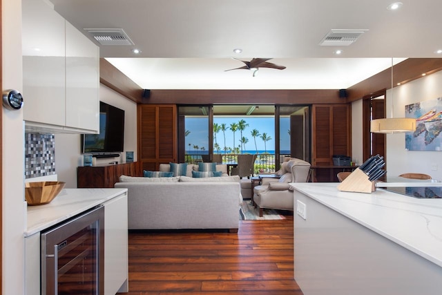 living area with beverage cooler, dark wood-style floors, visible vents, and recessed lighting