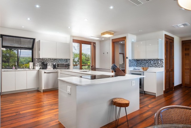 kitchen featuring stainless steel appliances, modern cabinets, visible vents, and white cabinetry