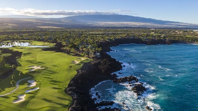 birds eye view of property featuring view of golf course and a water and mountain view