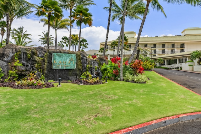 view of front of home with a balcony and a front yard