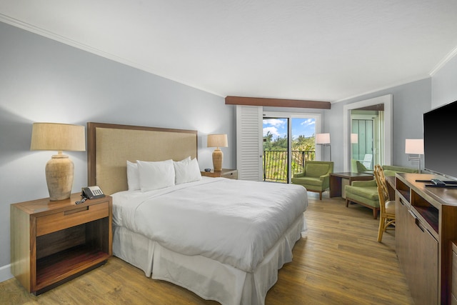 bedroom with access to outside, hardwood / wood-style flooring, and ornamental molding