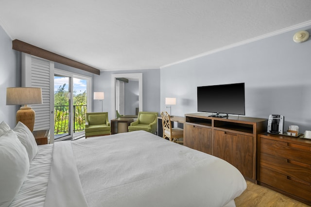 bedroom featuring ornamental molding, light wood-type flooring, and access to exterior