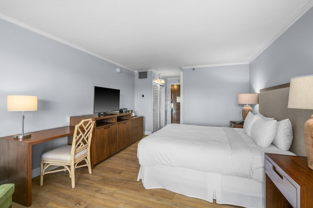 bedroom featuring hardwood / wood-style flooring and ornamental molding