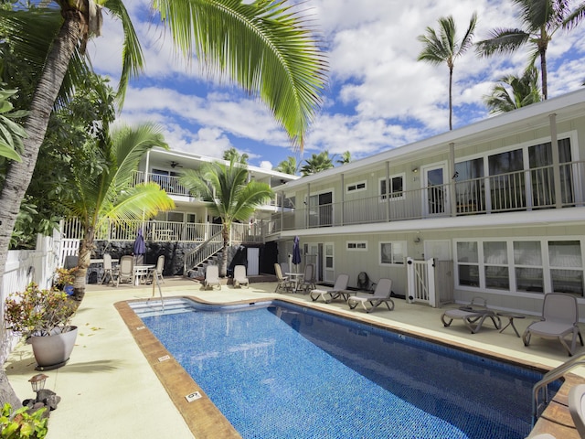 community pool featuring ceiling fan, a patio, and fence