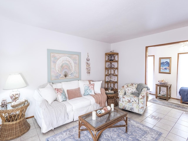 tiled living room featuring baseboards