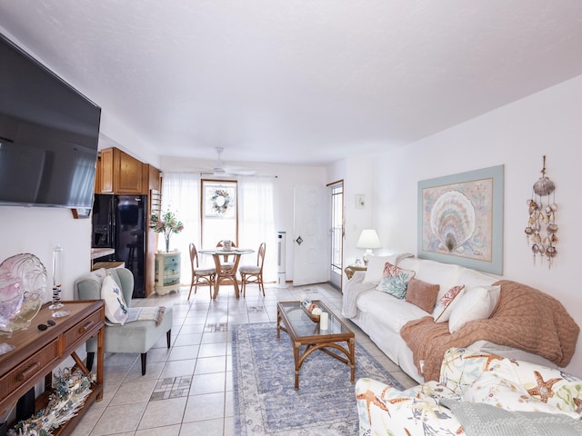 living room with light tile patterned floors and ceiling fan