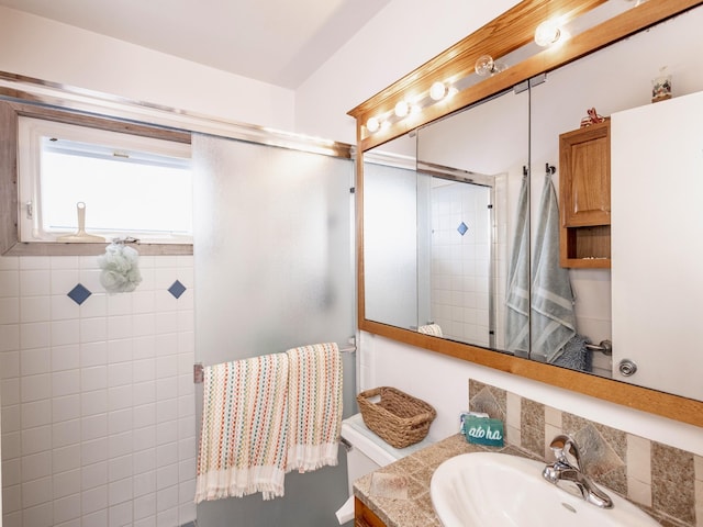 full bathroom featuring vanity, toilet, and an enclosed shower