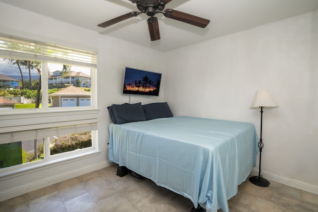 tiled bedroom with ceiling fan