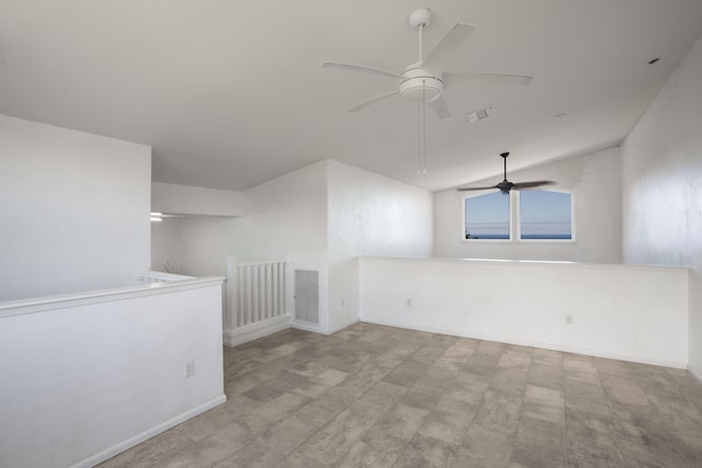 unfurnished room with ceiling fan and vaulted ceiling