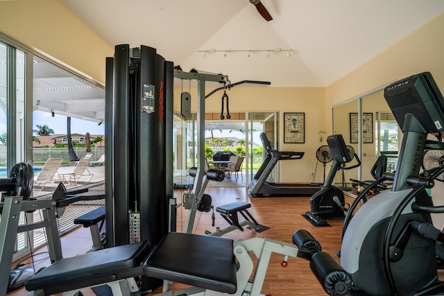 gym featuring hardwood / wood-style floors and vaulted ceiling