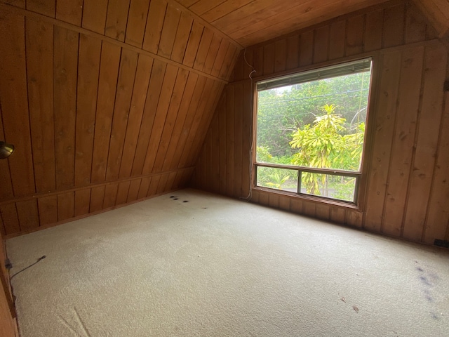 bonus room with wood walls, carpet flooring, vaulted ceiling, and wooden ceiling