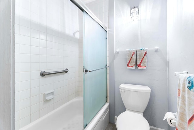 bathroom featuring toilet and enclosed tub / shower combo