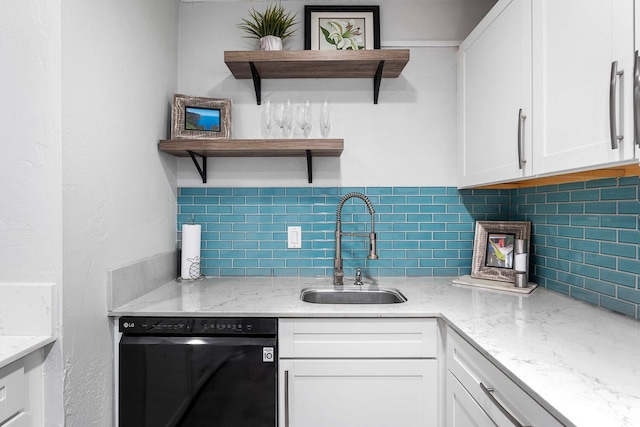 kitchen featuring black dishwasher, white cabinetry, sink, and tasteful backsplash