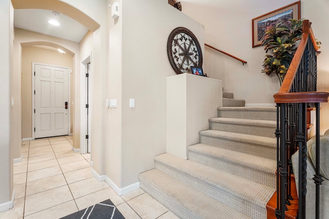 stairway featuring tile patterned flooring