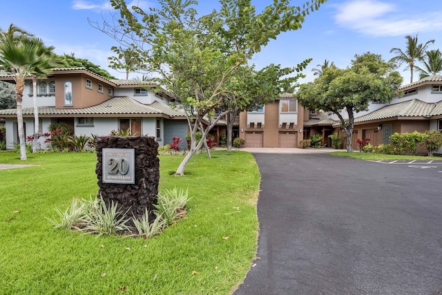 view of front of home featuring a garage and a front lawn