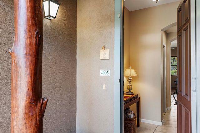 corridor featuring light tile patterned floors