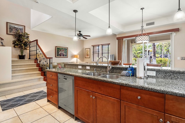 kitchen with stainless steel dishwasher, sink, stone countertops, light tile patterned floors, and ceiling fan