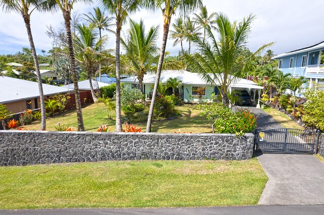 view of front of house featuring a balcony and a front lawn