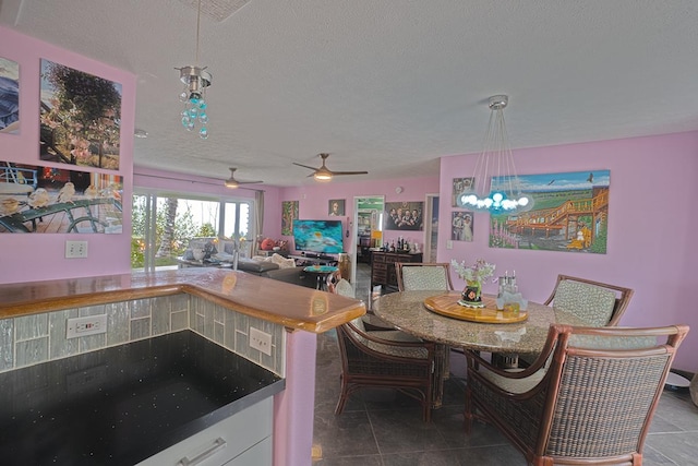 kitchen with white cabinets, decorative light fixtures, tile patterned flooring, a textured ceiling, and a chandelier