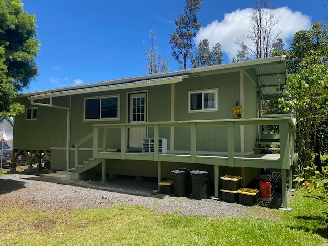 back of property with a wooden deck