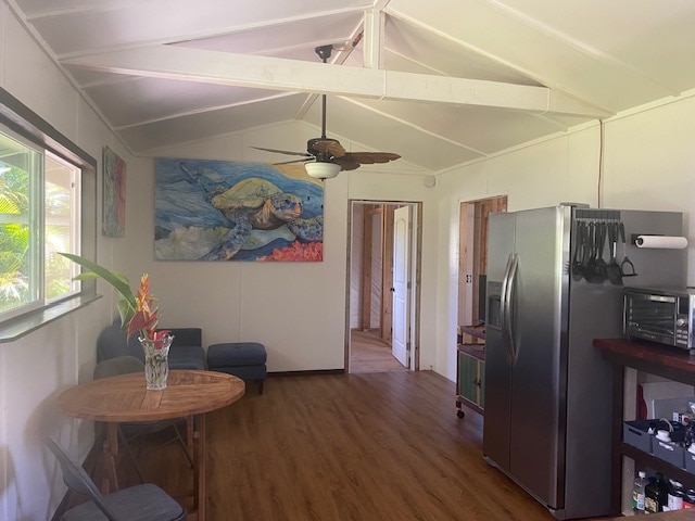 interior space featuring stainless steel fridge with ice dispenser, wood-type flooring, vaulted ceiling with beams, and ceiling fan