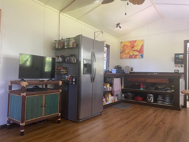 kitchen with vaulted ceiling, dark wood-type flooring, ceiling fan, and stainless steel fridge