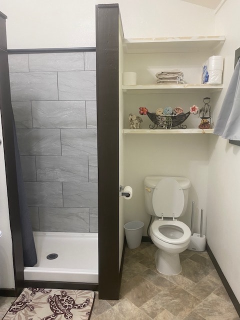 bathroom with tile walls and toilet