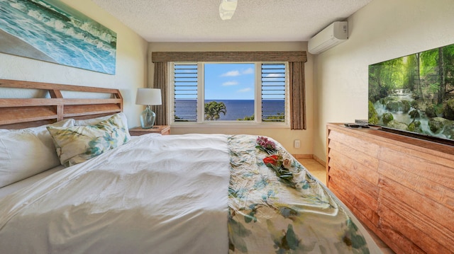 bedroom featuring ceiling fan, a textured ceiling, and a wall mounted AC