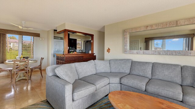 tiled living room with ceiling fan