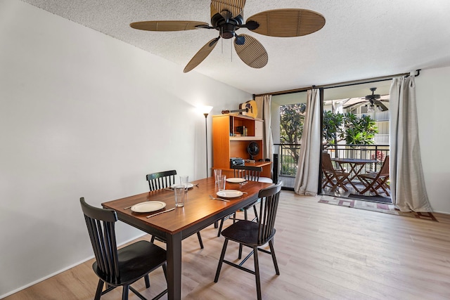 dining area with ceiling fan, light hardwood / wood-style flooring, and a textured ceiling