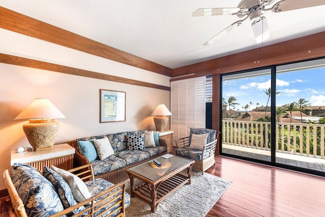 living area with hardwood / wood-style flooring and a ceiling fan