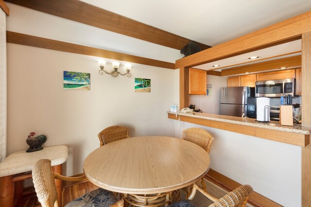 dining space with hardwood / wood-style flooring