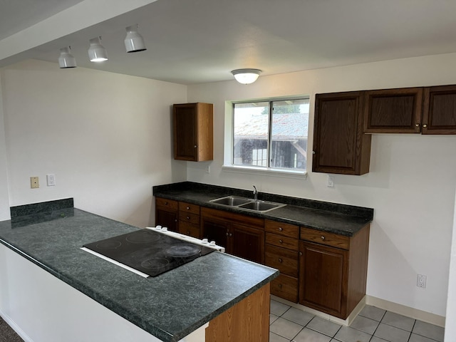 kitchen with sink, dark brown cabinets, light tile patterned floors, black electric cooktop, and kitchen peninsula