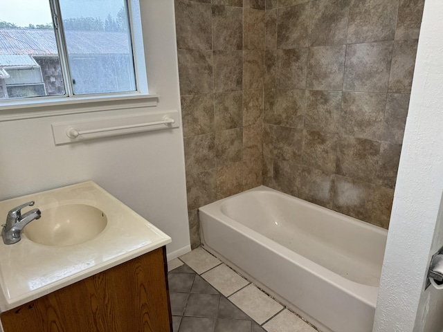 bathroom featuring tile patterned flooring, vanity, and shower / washtub combination