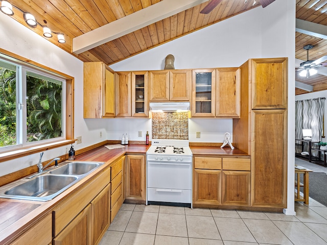 kitchen featuring lofted ceiling with beams, white range, sink, light tile patterned floors, and ceiling fan