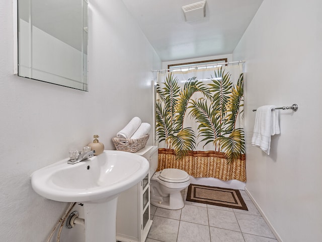 bathroom with sink, tile patterned floors, and toilet