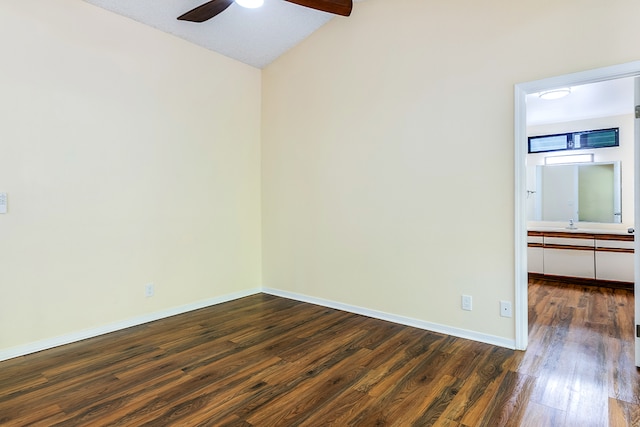 spare room featuring ceiling fan, vaulted ceiling with beams, and dark wood-type flooring